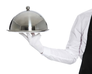 Photo of Young waiter holding metal tray with lid on white background
