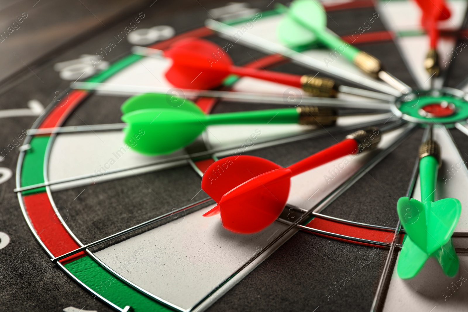 Photo of Red and green arrows on dart board, closeup