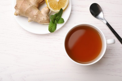 Flat lay composition with cup of tea and space for text on white wooden background. Cough remedies