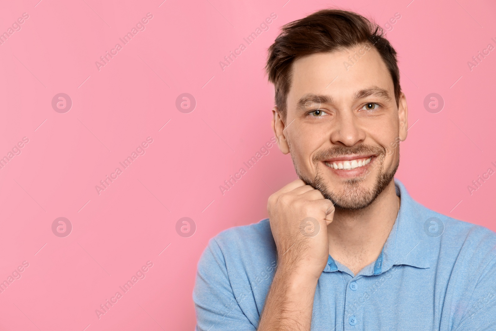 Photo of Smiling man with perfect teeth on color background. Space for text