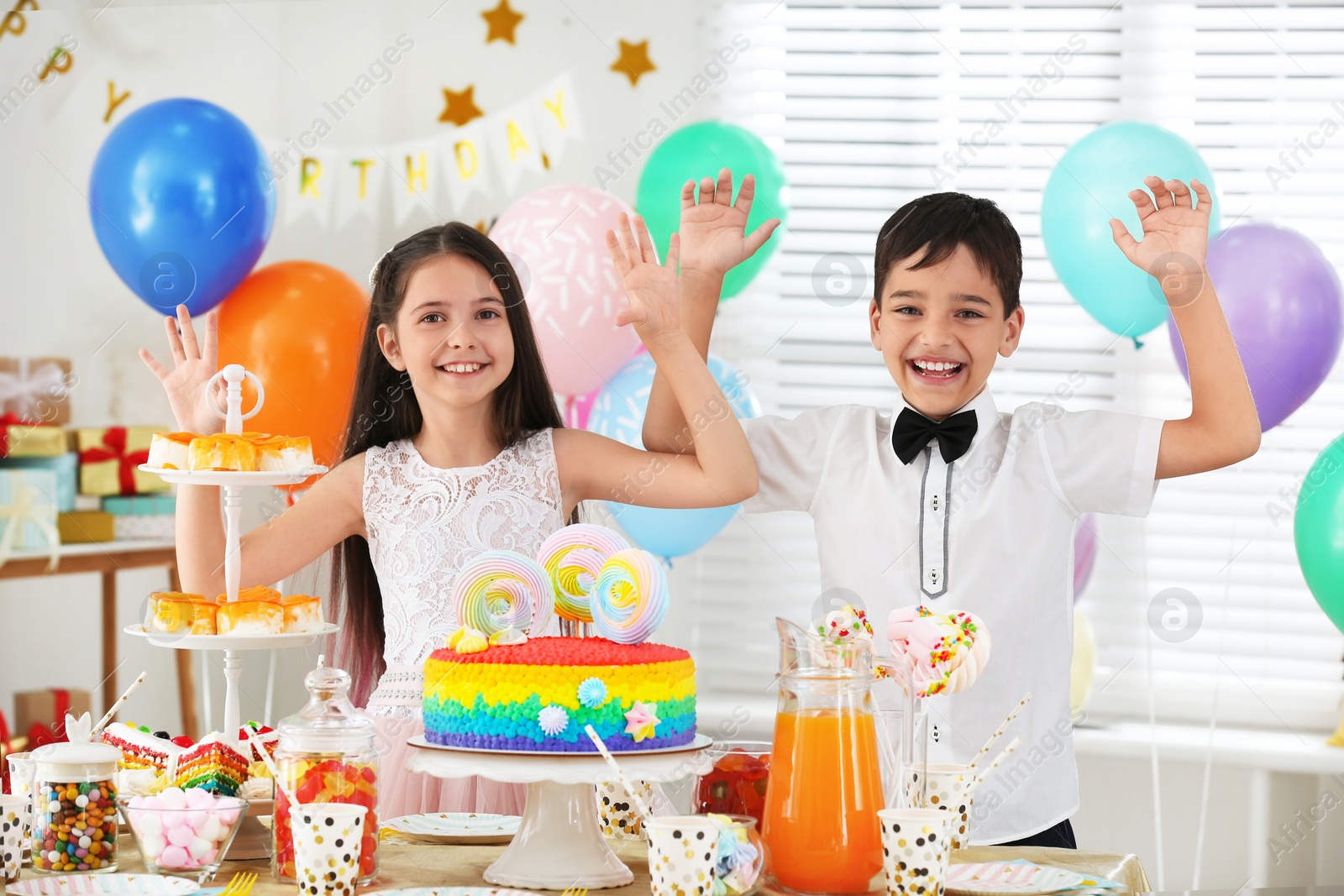 Photo of Happy children at birthday party in decorated room