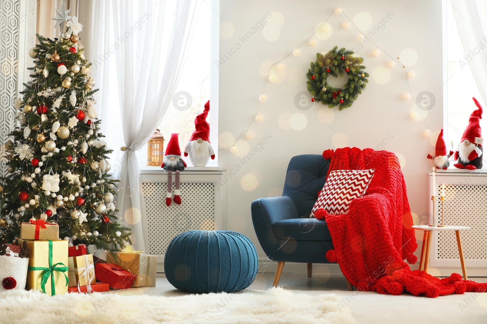 Photo of Cute Christmas gnomes in room with other festive decorations