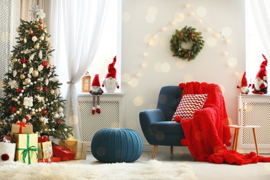 Photo of Cute Christmas gnomes in room with other festive decorations