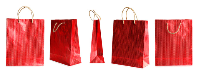 Image of Set of paper shopping bags on white background