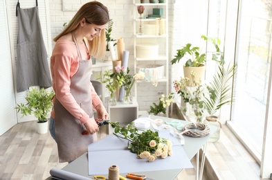 Female florist creating bouquet at workplace