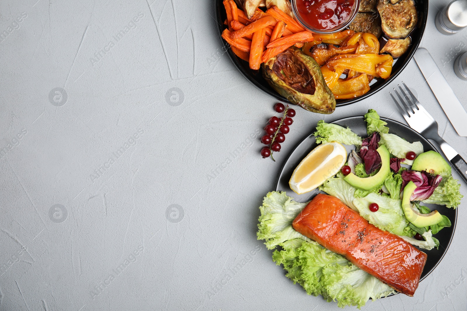 Photo of Tasty cooked salmon and fresh salad served on grey table, flat lay with space for text. Healthy meals from air fryer