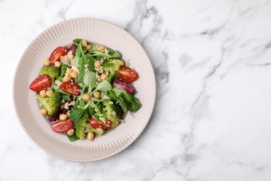 Photo of Healthy meal. Tasty salad with quinoa, chickpeas and vegetables on white marble table, top view with space for text