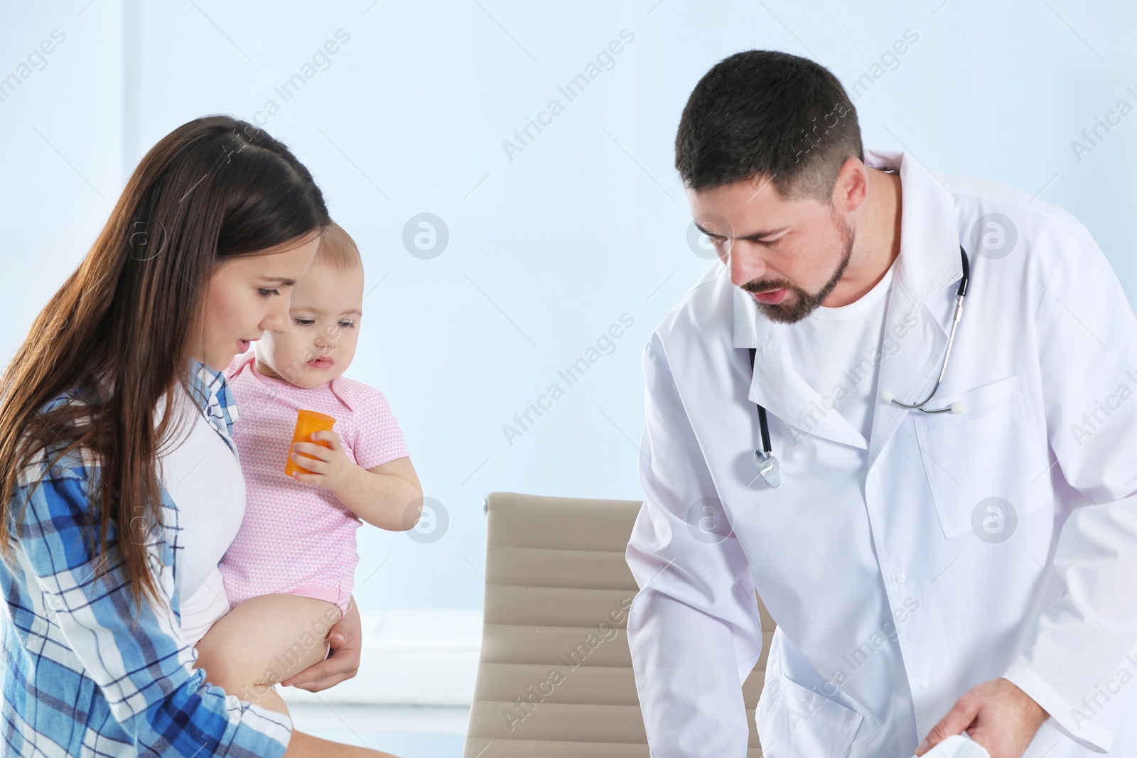 Photo of Woman with daughter visiting children's doctor in hospital