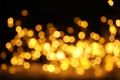 Photo of Gold glitter with bokeh effect on dark background