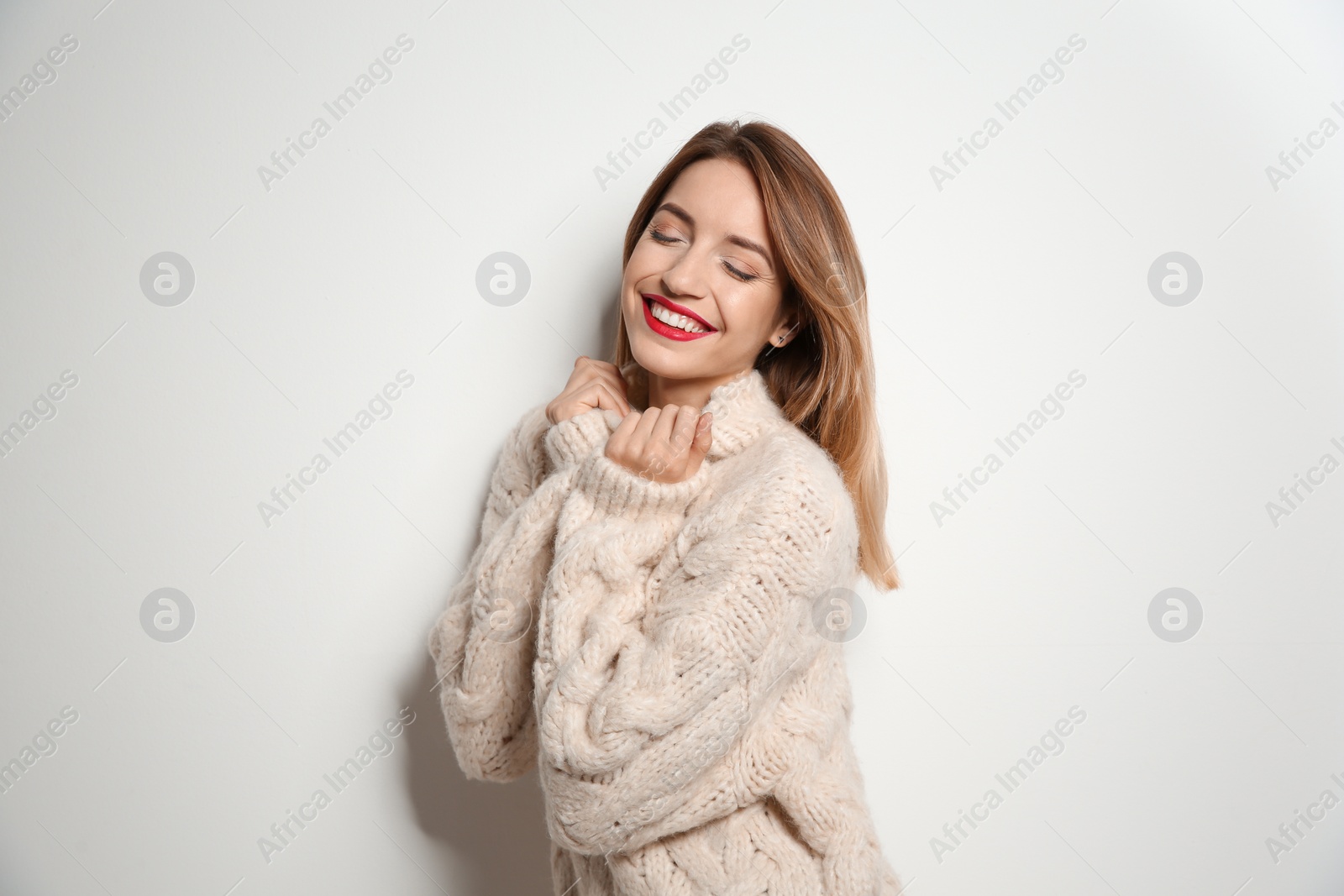 Photo of Beautiful young woman in warm sweater on white background