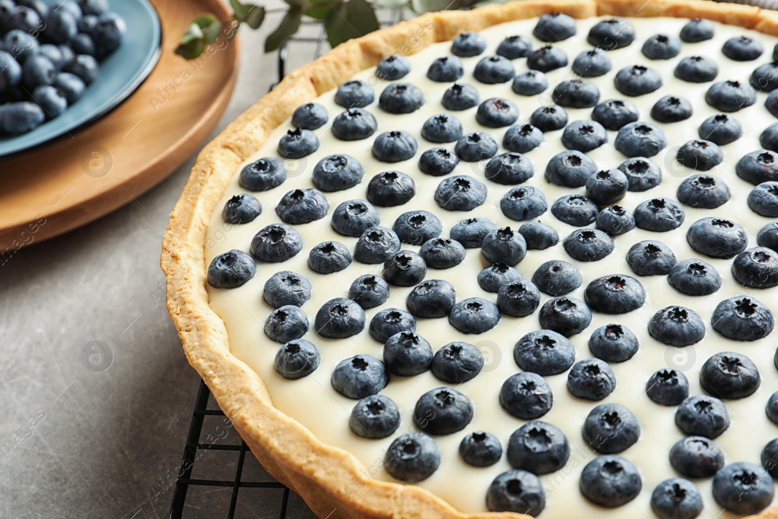 Photo of Tasty cake with blueberry on gray table