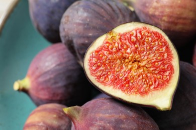 Photo of Many fresh ripe figs on plate, closeup