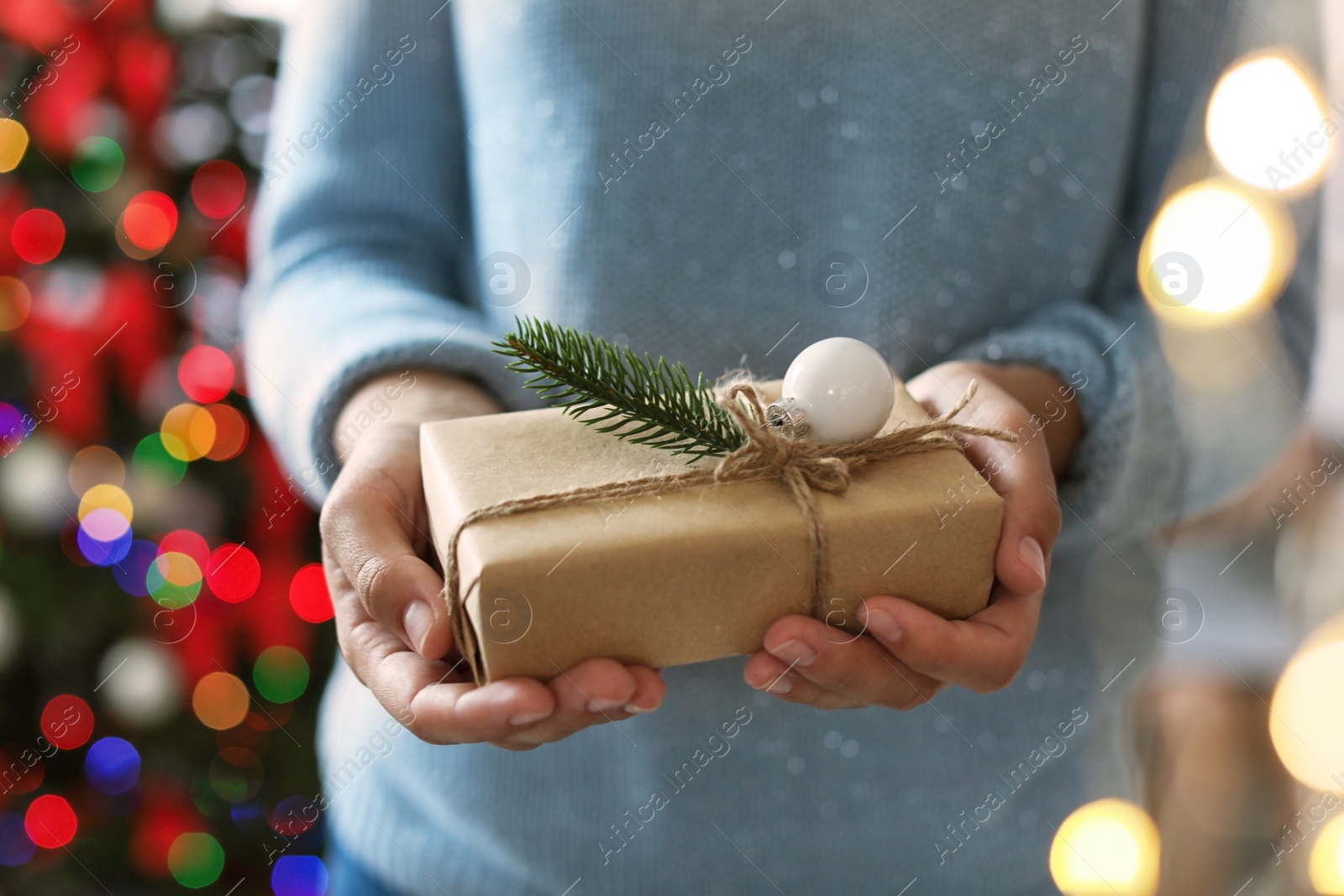 Photo of Woman holding Christmas gift box, closeup