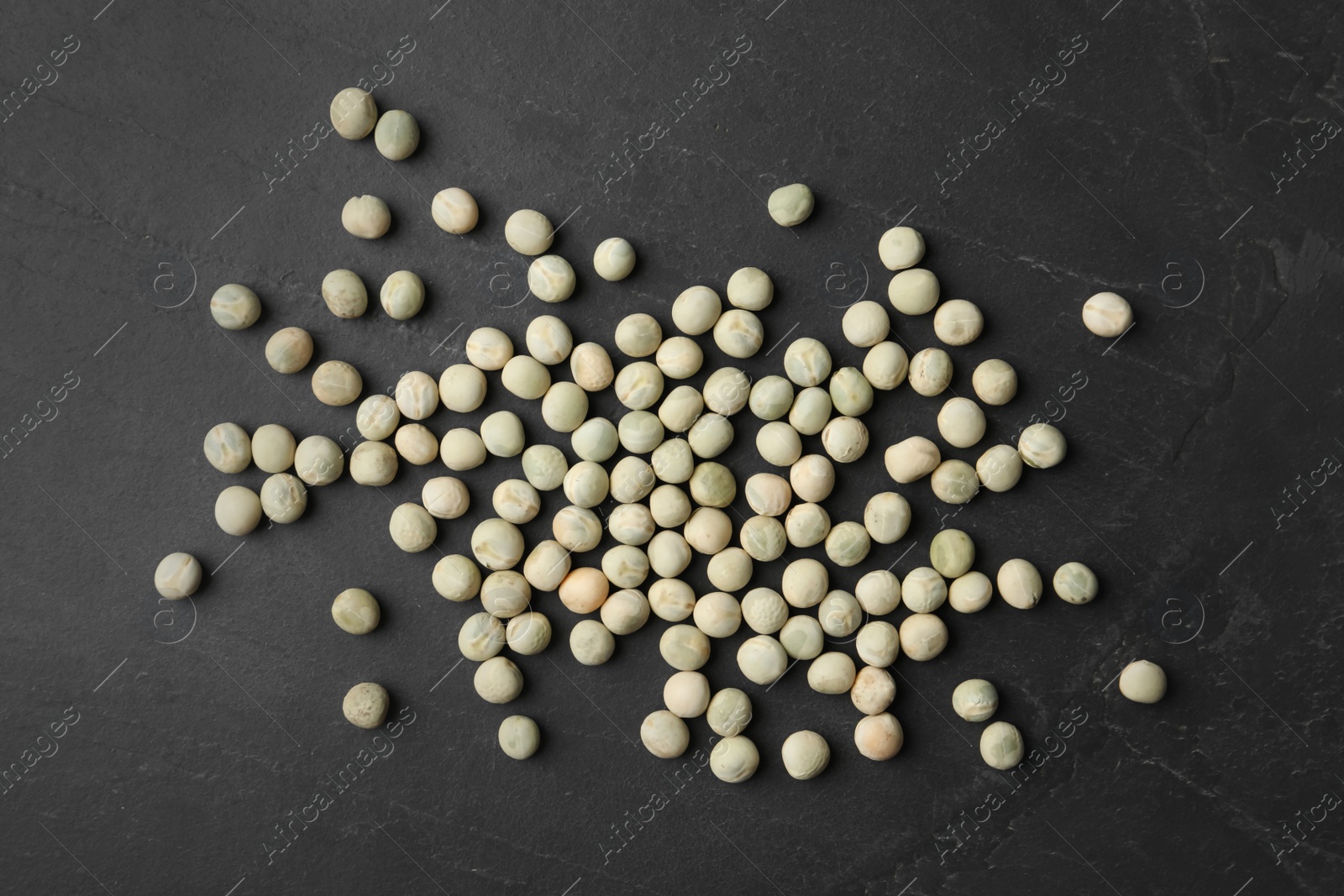 Photo of Raw dry peas on black background, flat lay. Vegetable seeds