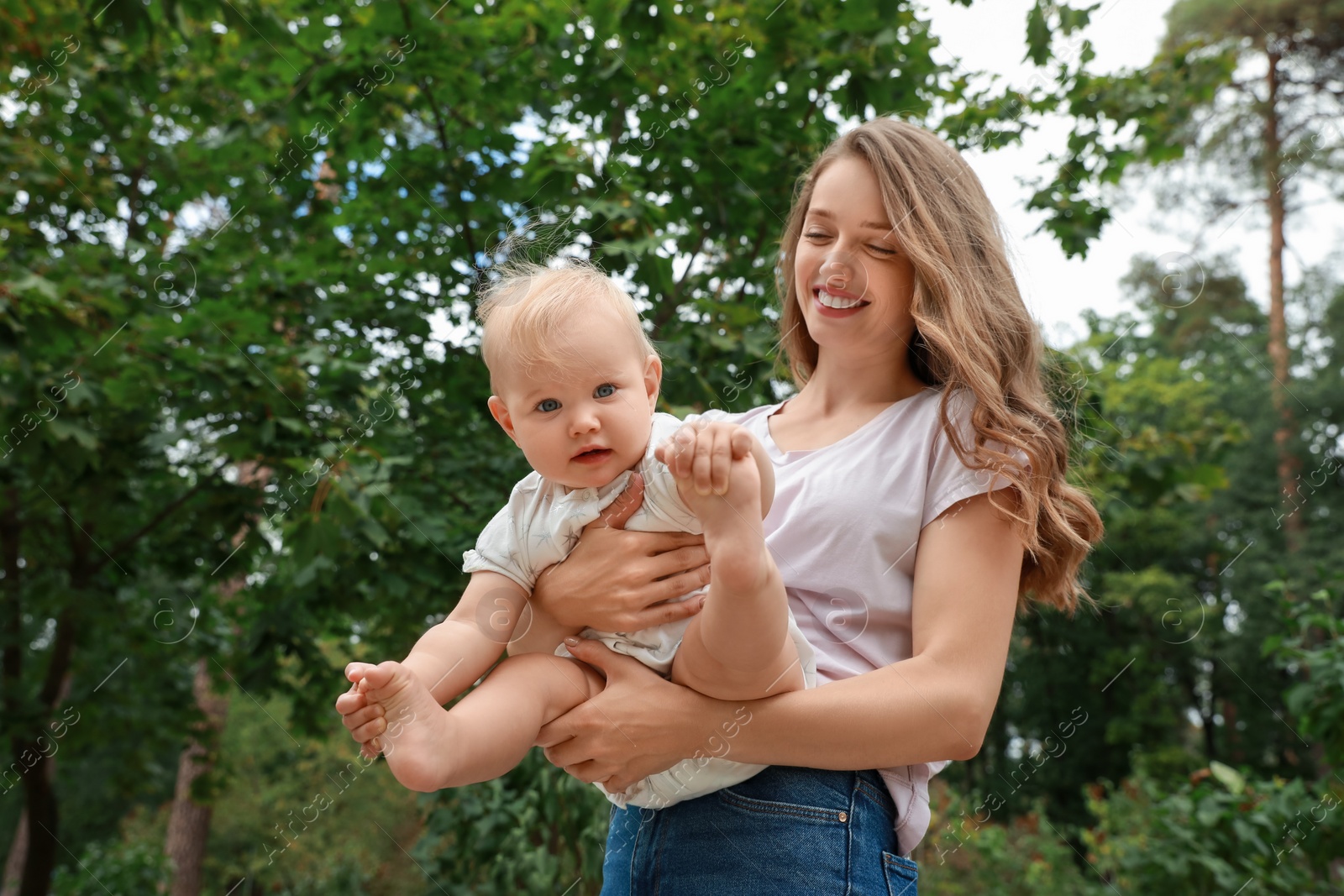 Photo of Mother with her cute baby spending time together outdoors