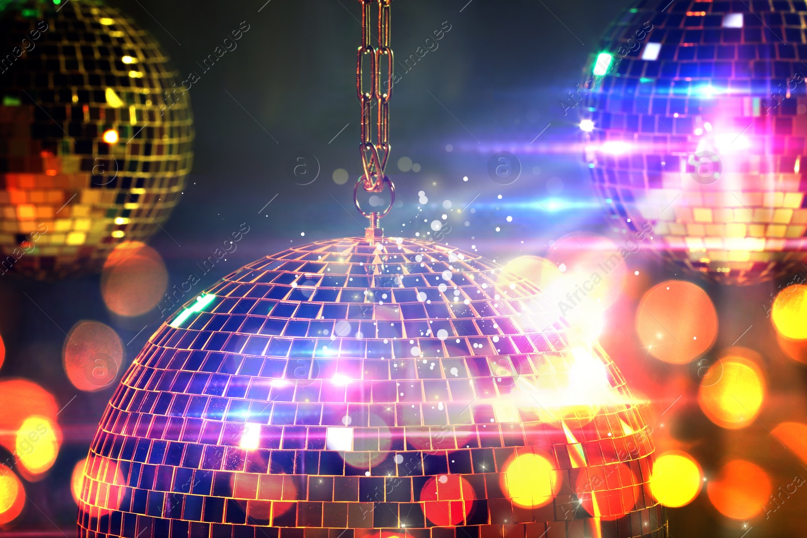 Image of Shiny disco balls on dark background with blurred lights, bokeh effect