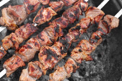 Photo of Cooking delicious kebab on metal brazier, above view