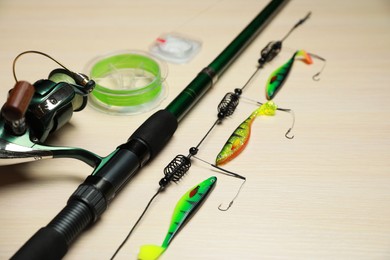 Fishing tackle on light wooden background, closeup