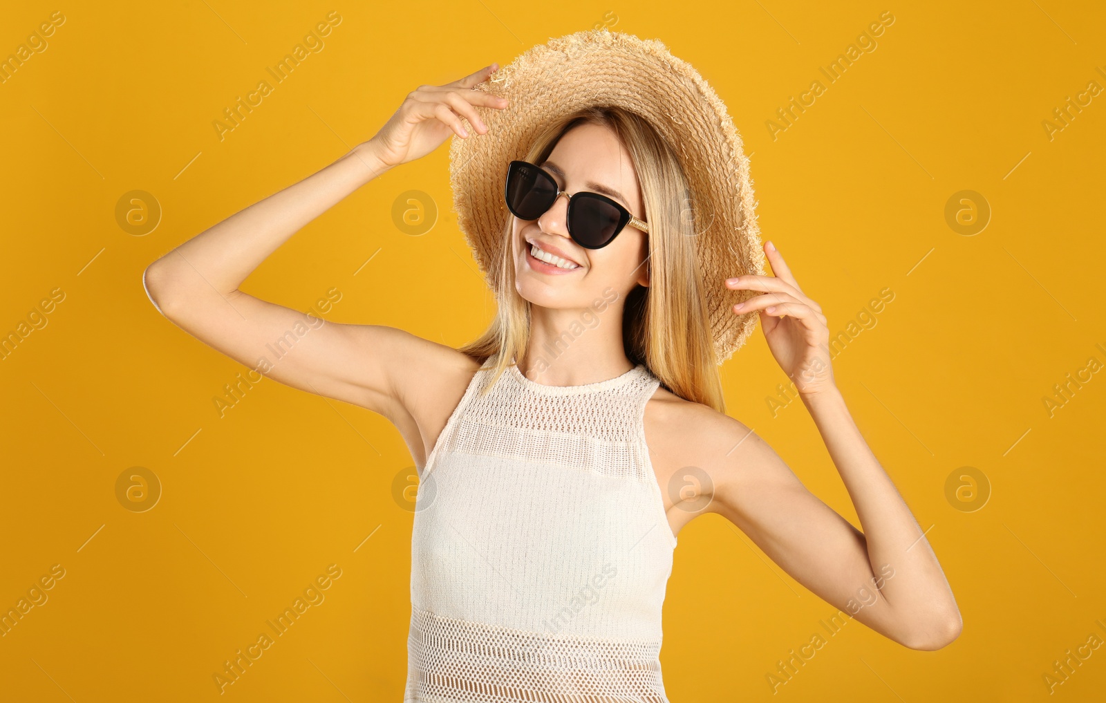 Photo of Beautiful woman in stylish sunglasses on yellow background