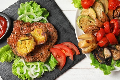 Photo of Tasty grilled dishes served on table, top view