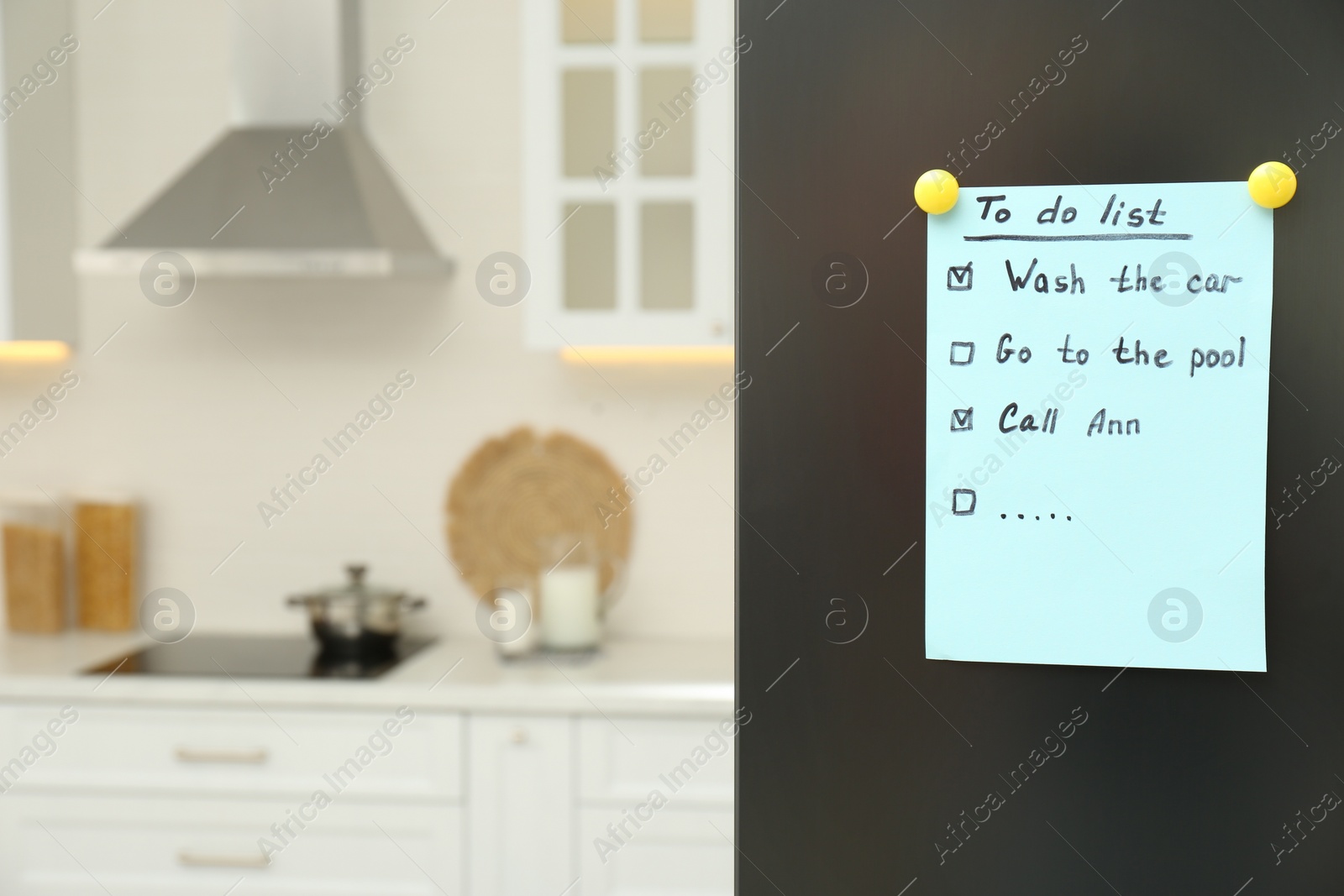 Photo of To do list on fridge in kitchen. Space for text