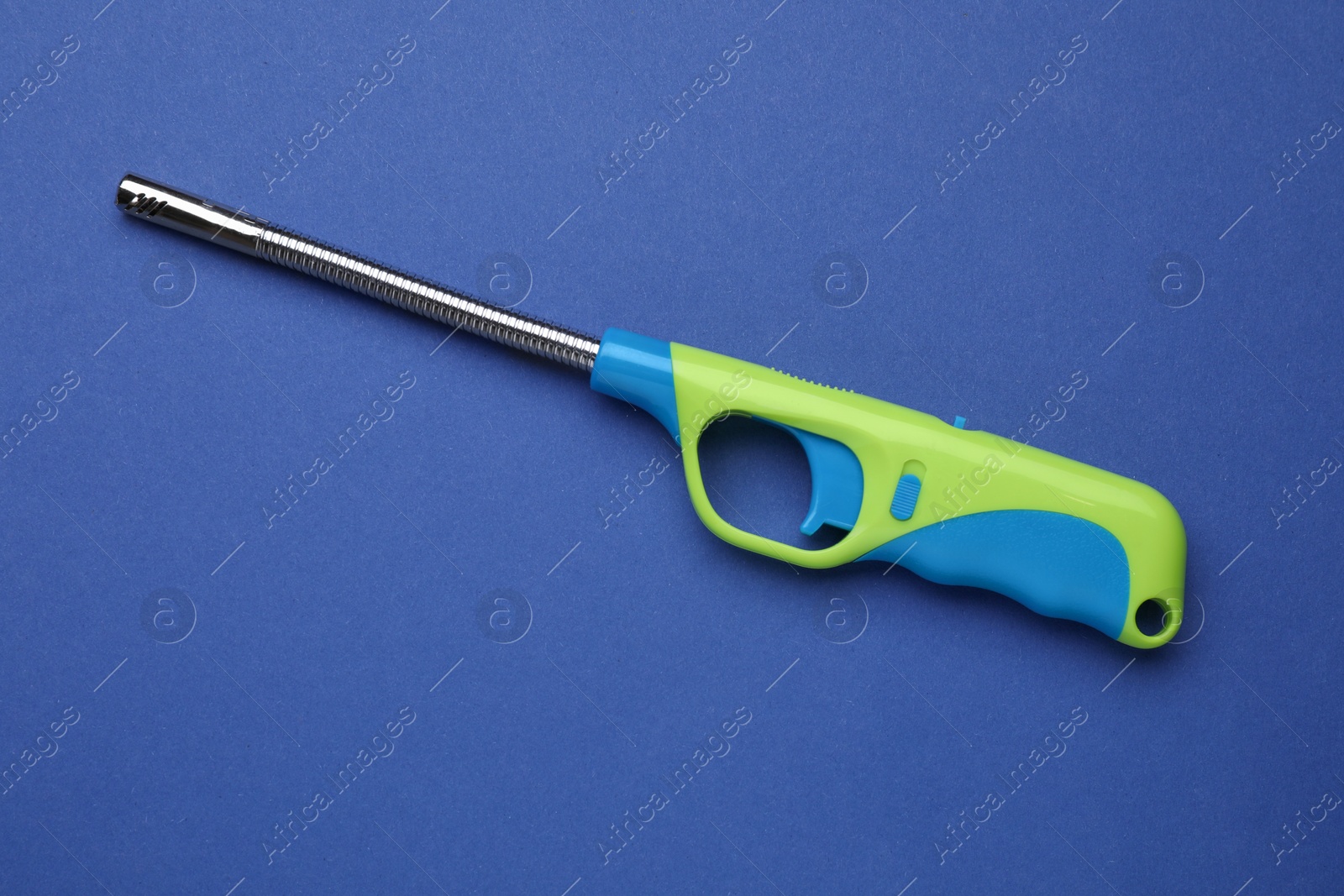 Photo of One gas lighter on blue background, top view