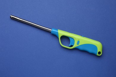 Photo of One gas lighter on blue background, top view