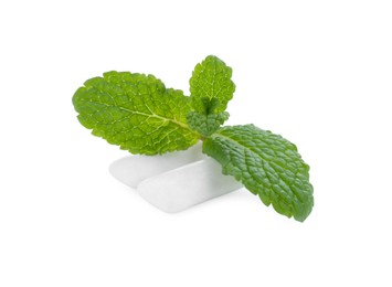 Photo of Two chewing gum pieces and mint on white background