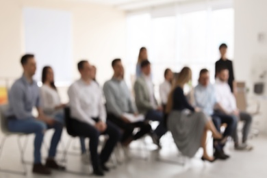 Photo of Young people having business training in office, blurred view