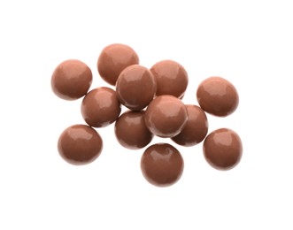 Delicious pink chocolate candies on white background, top view