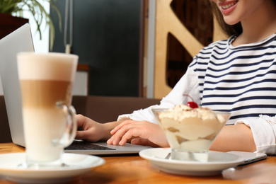 Blogger working with laptop in cafe, closeup