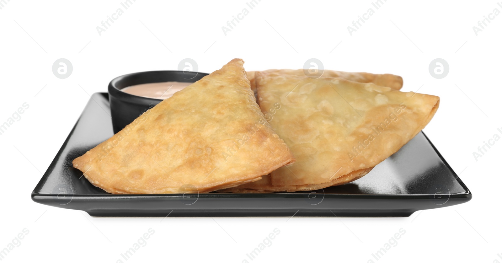 Photo of Fresh delicious crispy samosas with sauce on white background