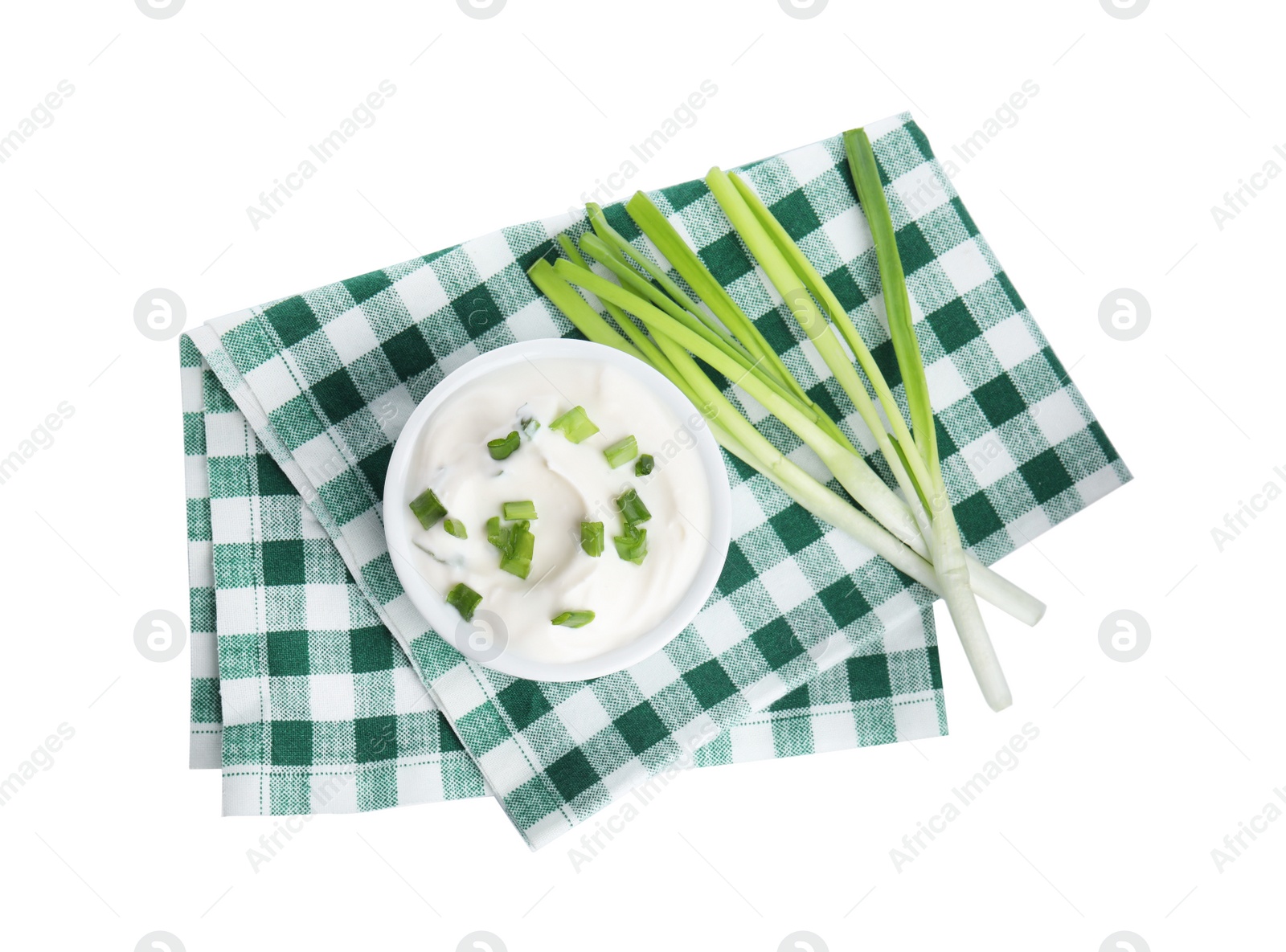 Photo of Fresh sour cream with onion and fabric on white background, top view