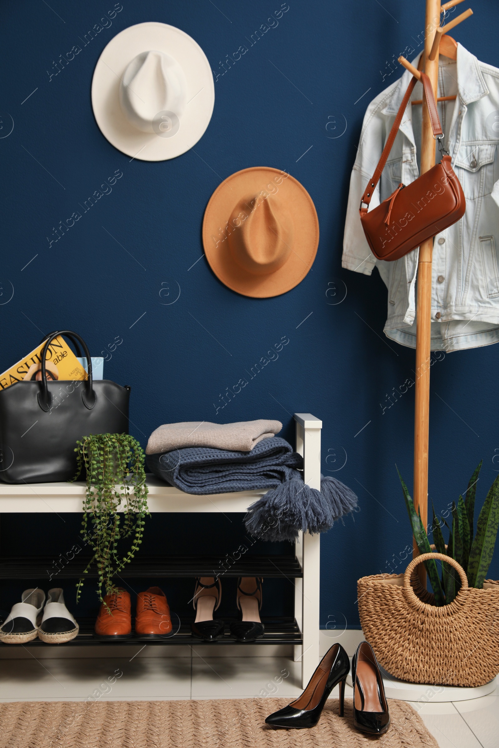 Photo of Hallway interior with stylish furniture, clothes and accessories