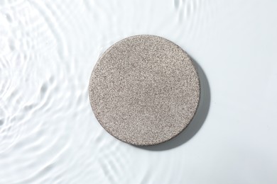 Photo of Presentation for product. Stone podium in water on white background, top view