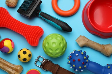Photo of Flat lay composition with different pet toys and accessories on light blue background