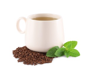 Photo of Cup of aromatic buckwheat tea, granules and mint on white background