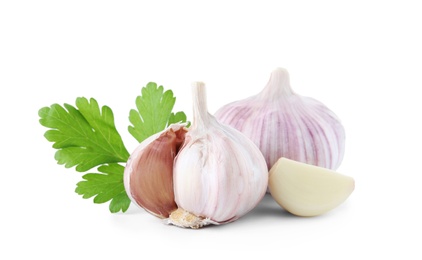 Photo of Fresh garlic and parsley on white background