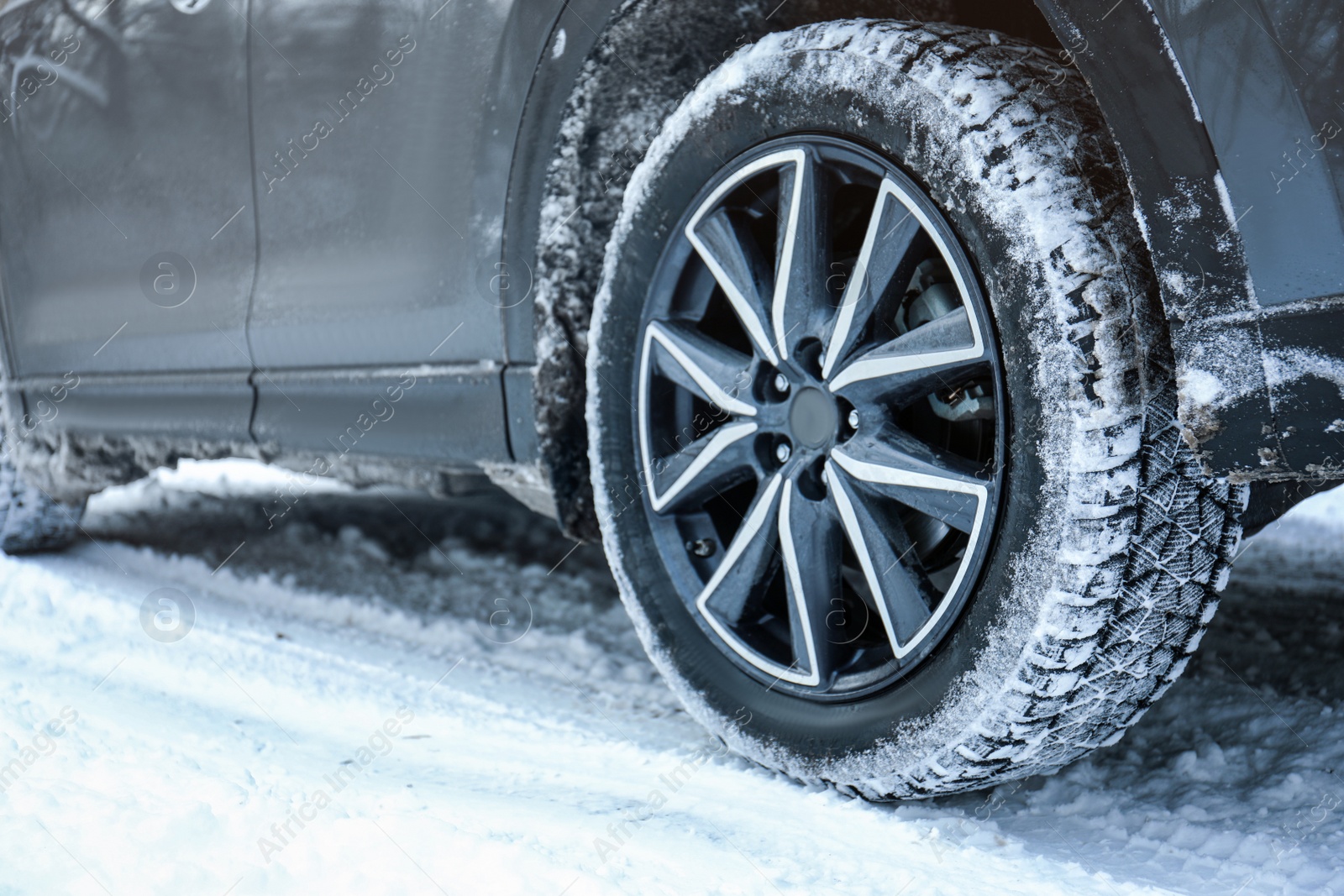 Photo of Snowy country road with car on winter day, closeup