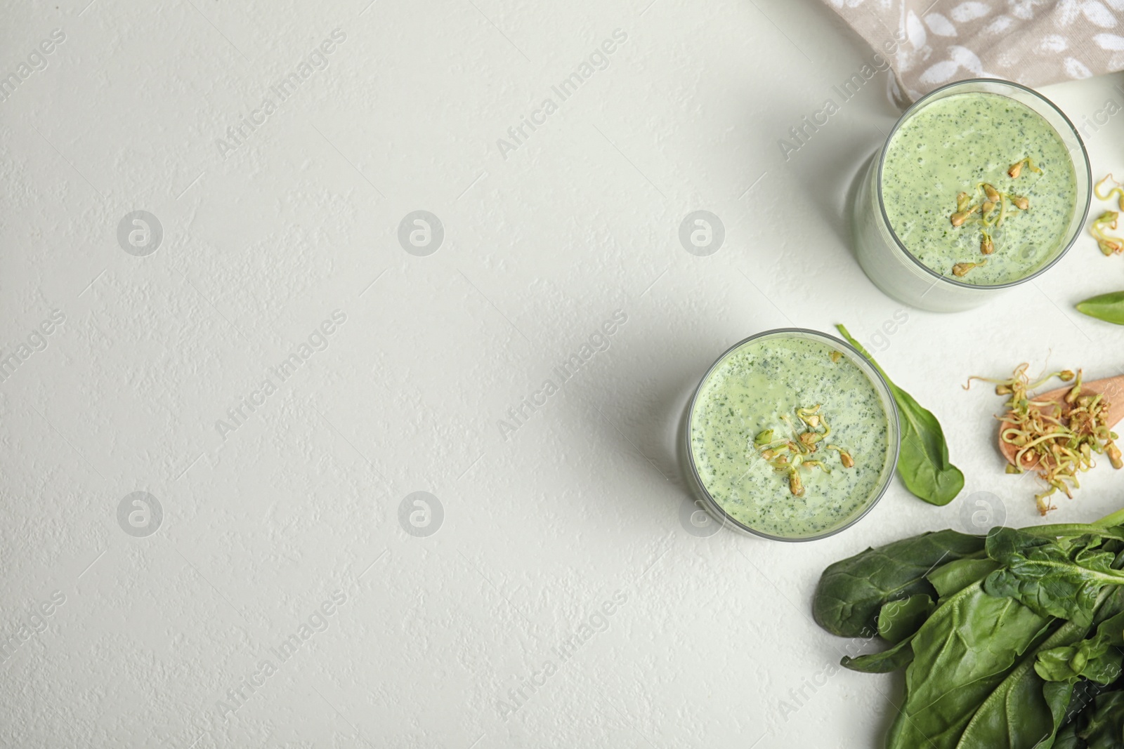 Photo of Flat lay composition with green buckwheat smoothie on white table, space for text