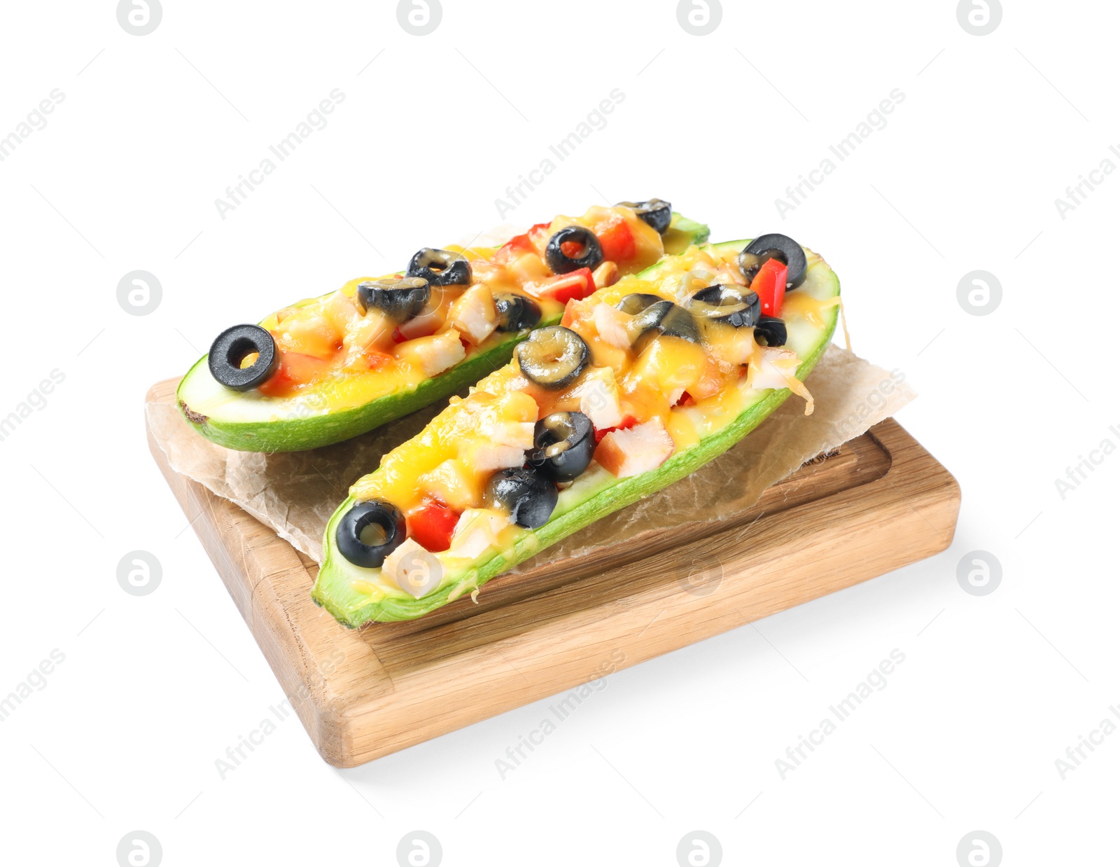 Photo of Wooden board with baked stuffed zucchinis on white background