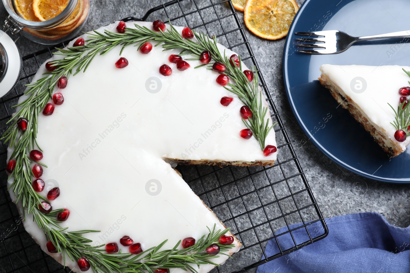 Photo of Flat lay composition with traditional Christmas cake on grey table