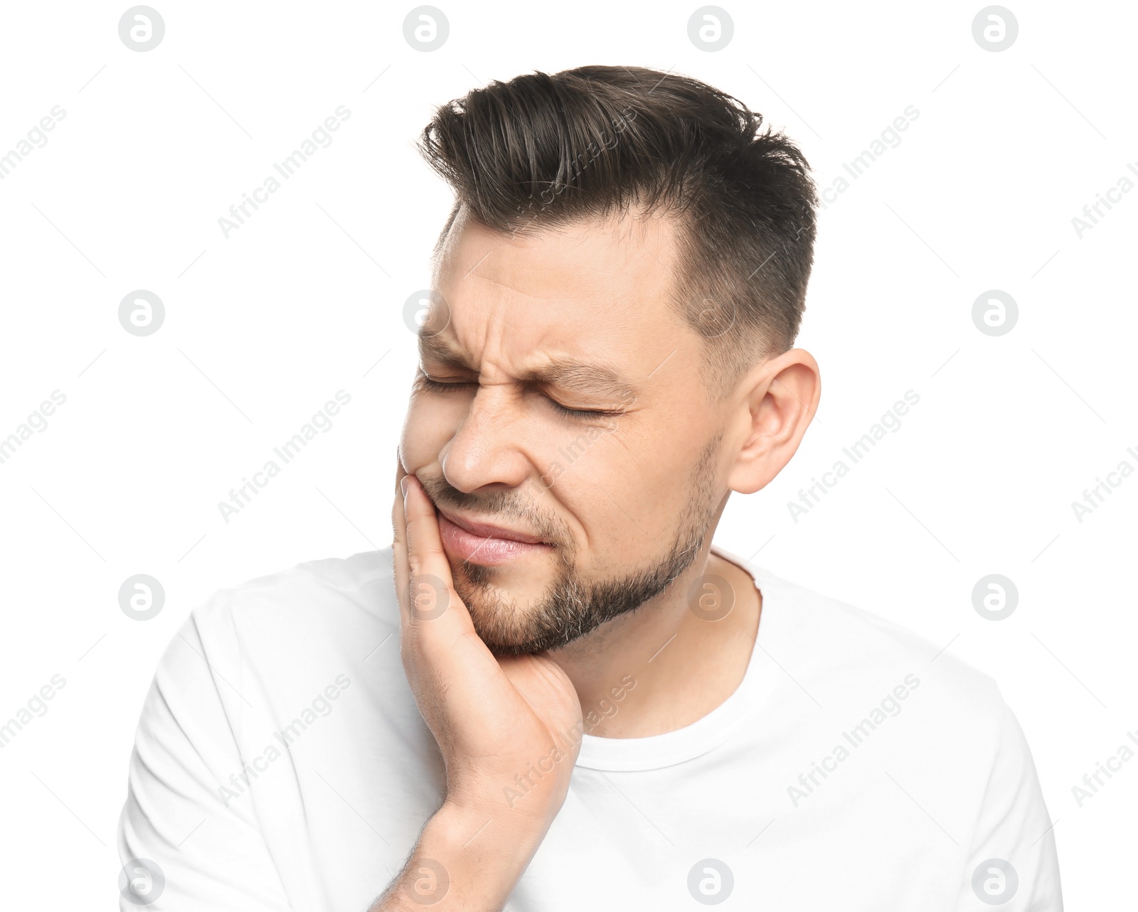 Photo of Young man suffering from toothache on white background