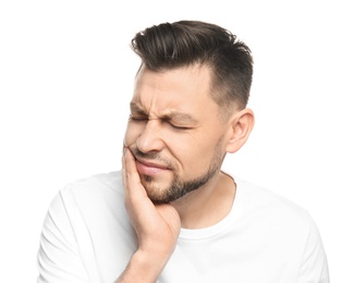 Photo of Young man suffering from toothache on white background