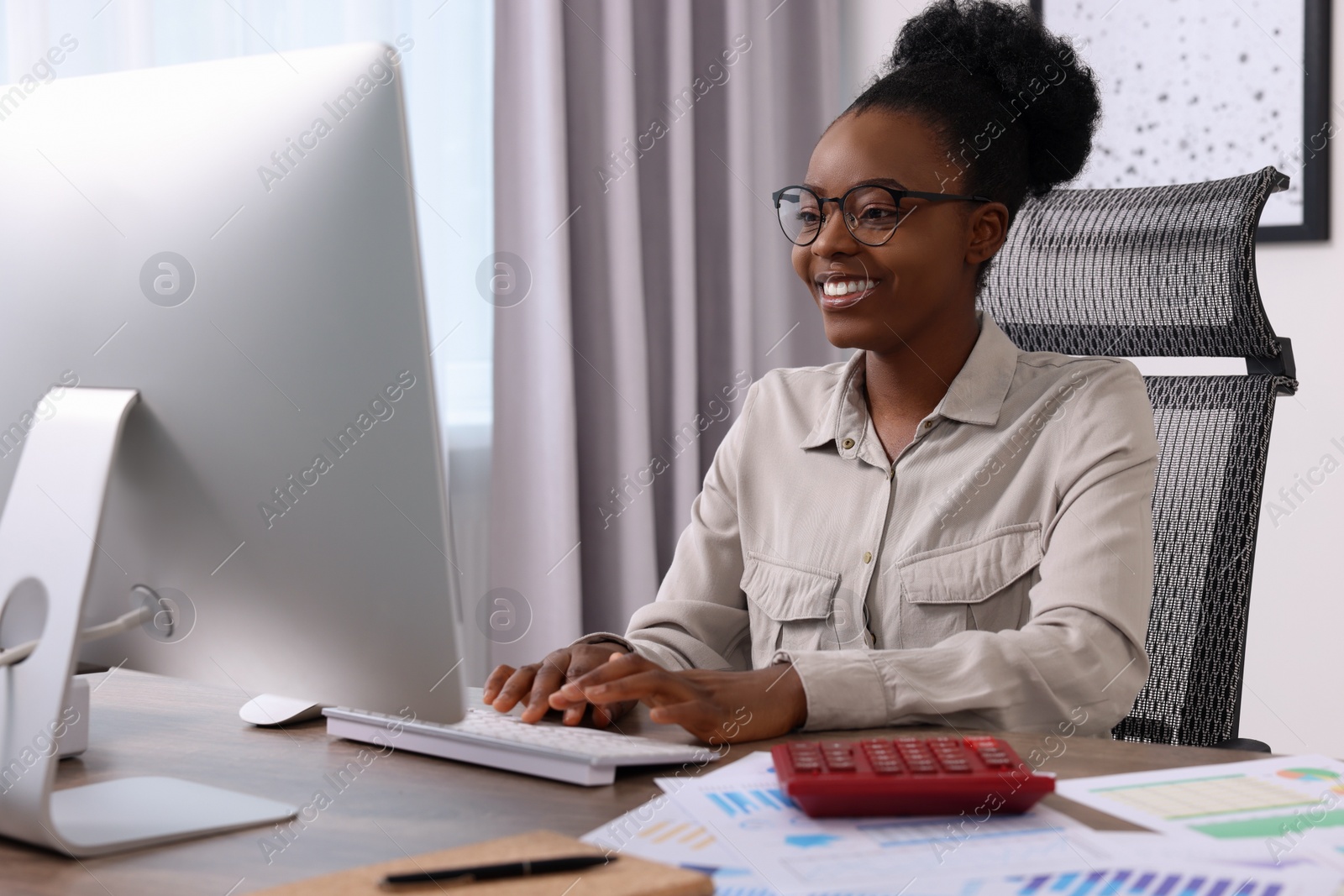 Photo of Professional accountant working on computer at wooden desk in office