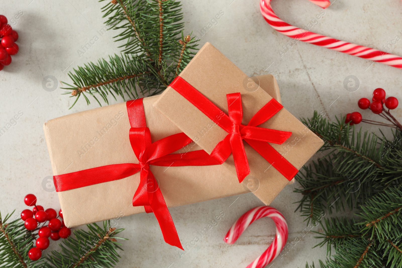 Photo of Flat lay composition with Christmas gift boxes and decor on light table