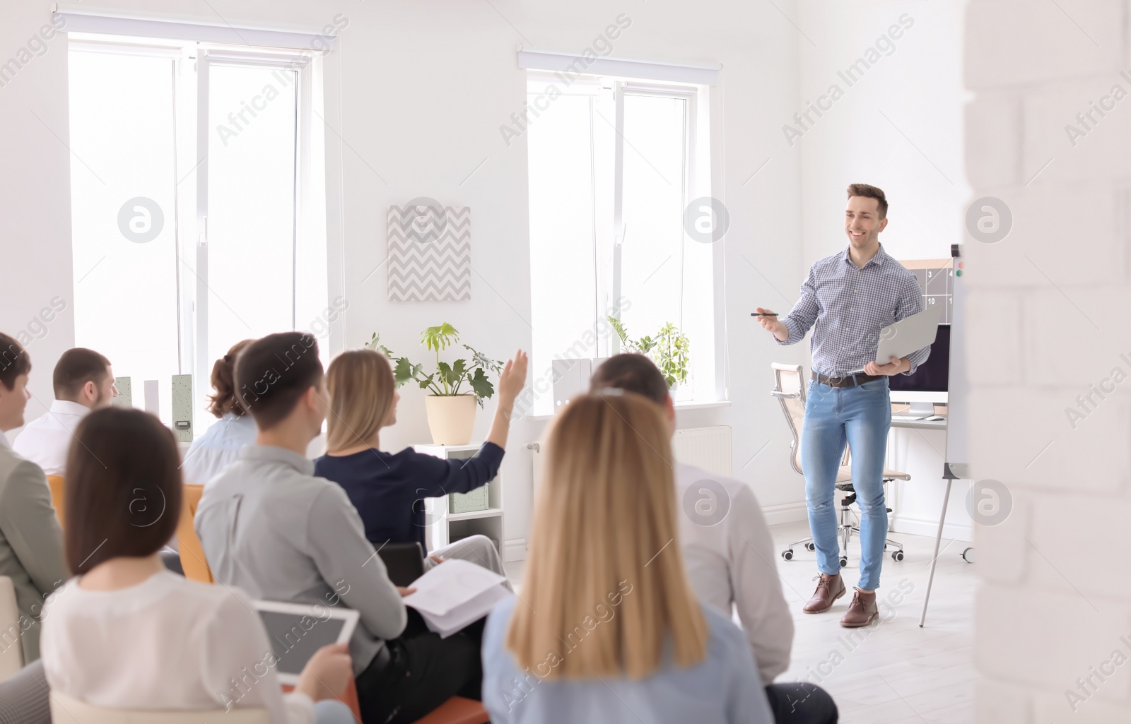 Photo of Male business trainer giving lecture in office