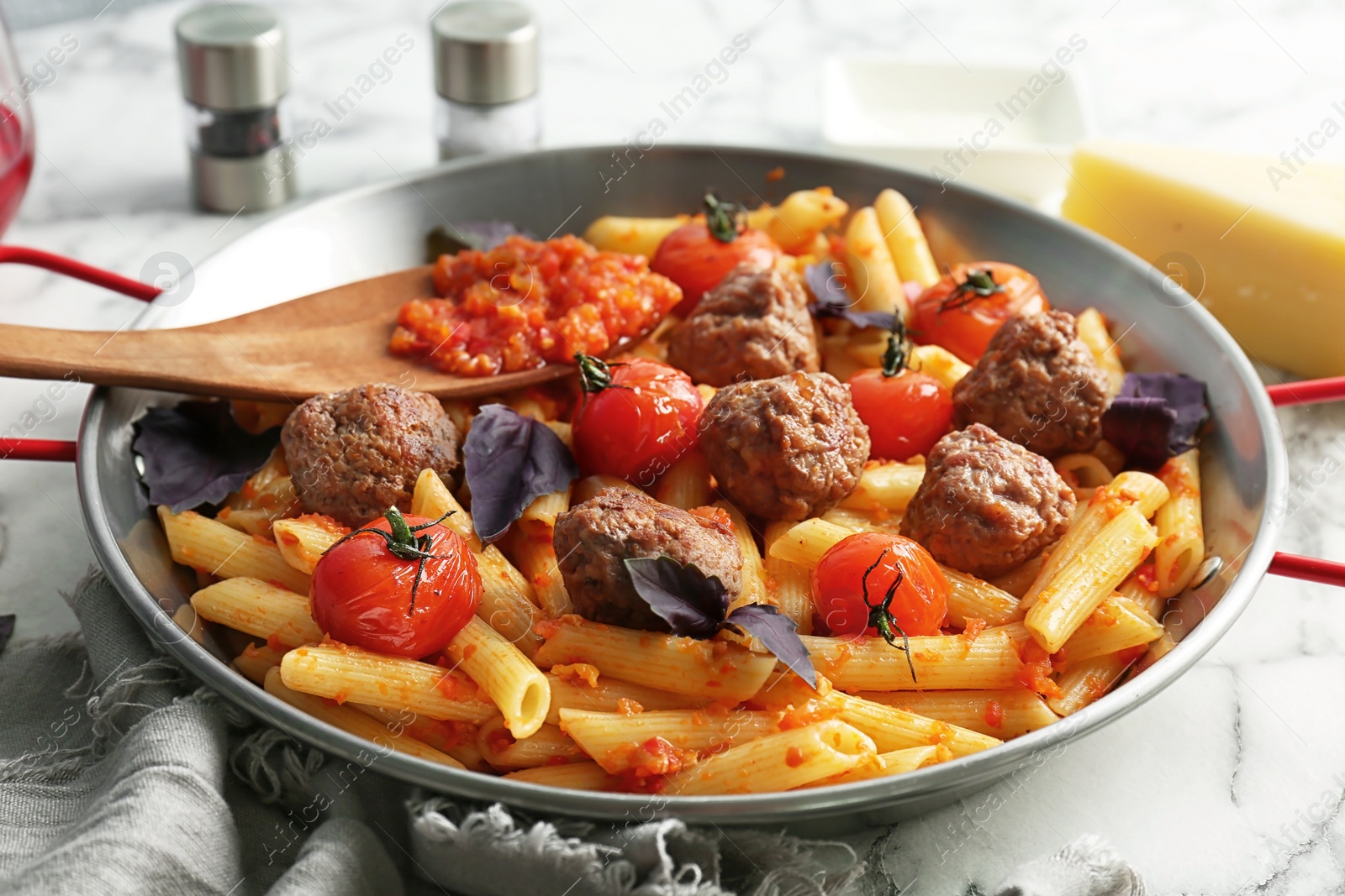 Photo of Pasta with meatballs and tomato sauce on table