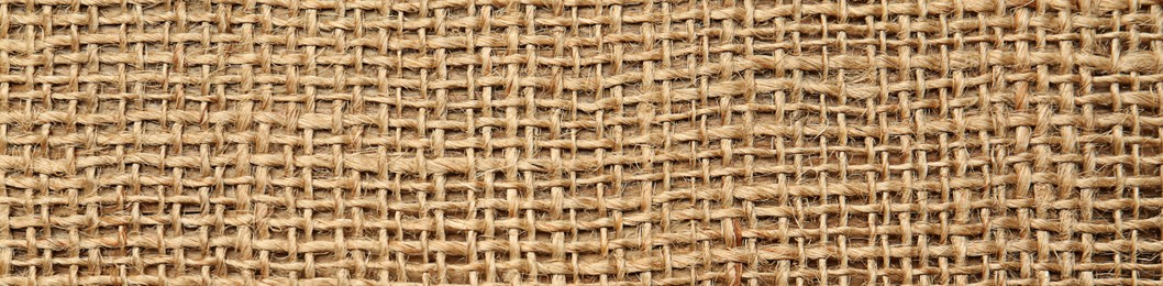 Texture of natural burlap fabric as background, top view. Banner design