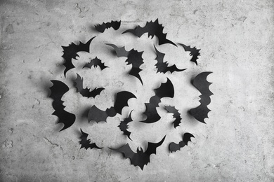 Photo of Paper bats on light grey background, flat lay. Halloween decor